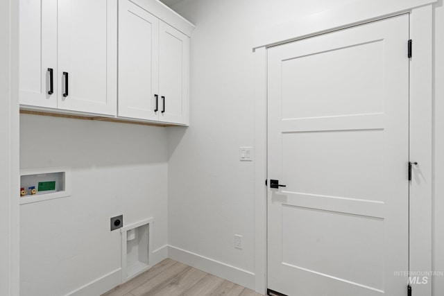 laundry area with cabinets, washer hookup, light hardwood / wood-style flooring, and electric dryer hookup