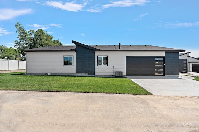 ranch-style home with central AC, a front lawn, and a garage