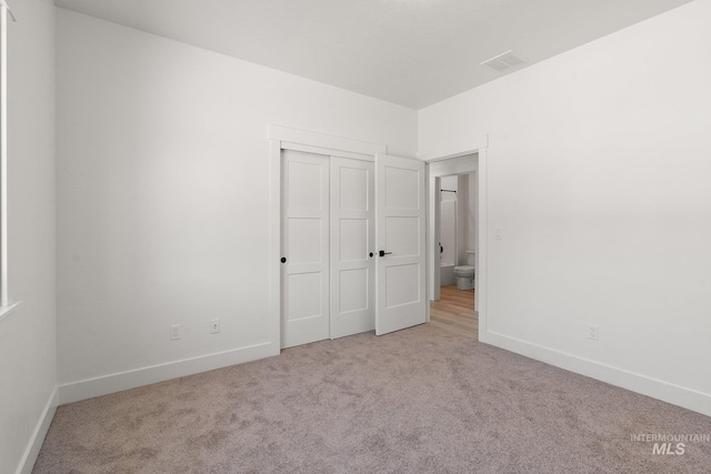 unfurnished bedroom featuring light carpet