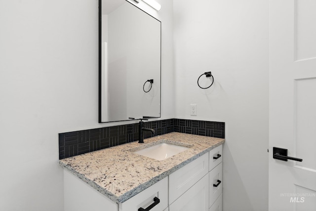 bathroom with decorative backsplash and vanity