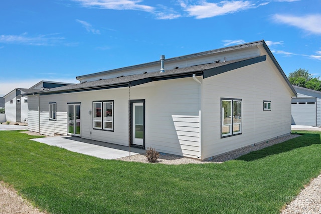 rear view of house with a yard and a patio