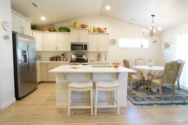 2431 Legacy Ct, Clarkston, WA 99403 - kitchen with appliances with stainless steel finishes, a sink, lofted ceiling, light countertops, and a chandelier