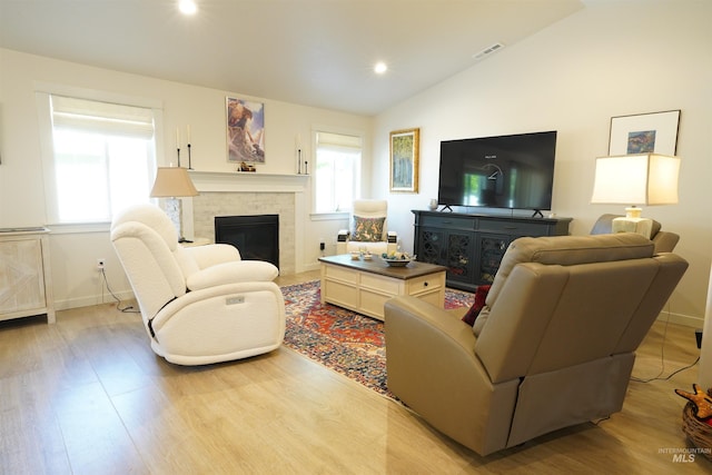 2431 Legacy Ct, Clarkston, WA 99403 - living room with light wood-type flooring, lofted ceiling, a glass covered fireplace, baseboards, and recessed lighting