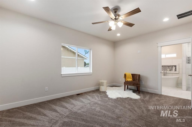 unfurnished room with ceiling fan and carpet flooring