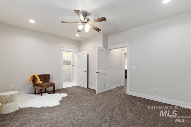 unfurnished room featuring ceiling fan and dark colored carpet