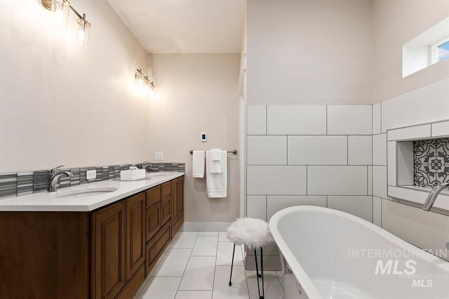 bathroom with tile patterned floors, vanity, a bathing tub, and tile walls