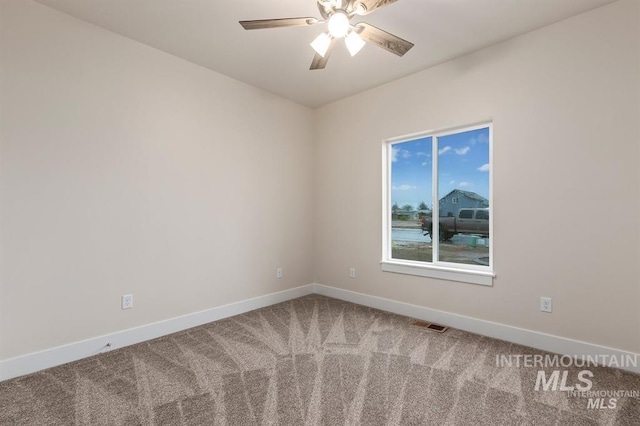 carpeted empty room featuring ceiling fan