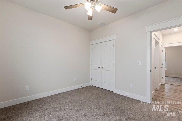 unfurnished bedroom featuring ceiling fan, carpet floors, and a closet