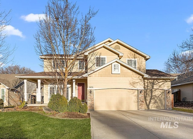 view of front facade featuring a garage, covered porch, driveway, and a front lawn