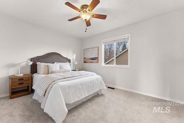 bedroom featuring carpet floors, visible vents, baseboards, and a ceiling fan