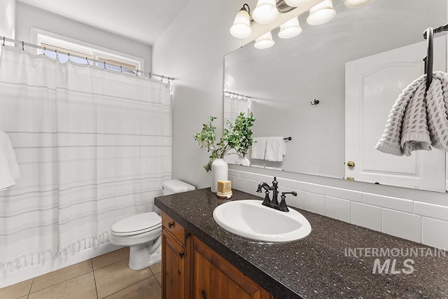 full bathroom with decorative backsplash, toilet, curtained shower, tile patterned flooring, and vanity