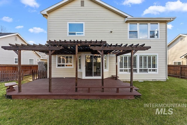 rear view of property with a deck, a yard, fence, and a pergola