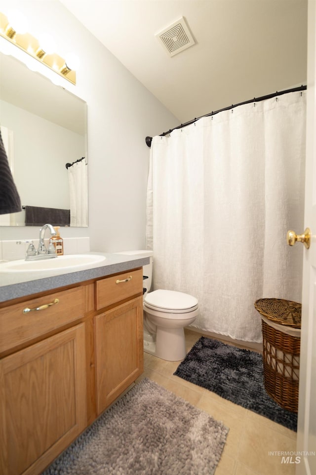 bathroom with vanity, tile patterned floors, toilet, and visible vents