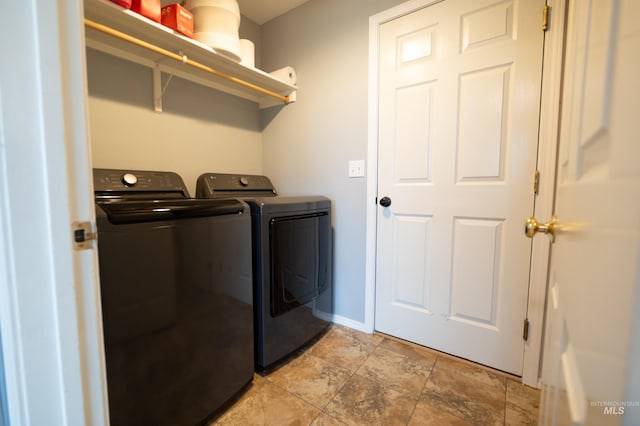 laundry room featuring baseboards, laundry area, and washing machine and clothes dryer