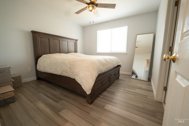 bedroom with baseboards, light wood-style floors, and ceiling fan