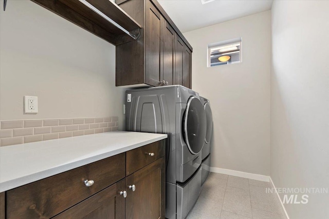 washroom featuring washing machine and dryer and cabinets