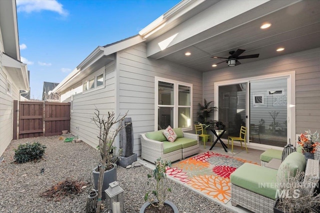 view of patio with an outdoor living space and ceiling fan