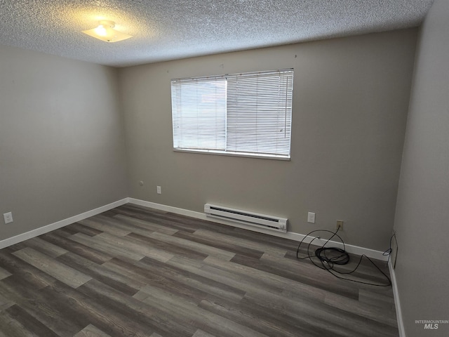 unfurnished room featuring baseboard heating, dark wood-type flooring, and a textured ceiling