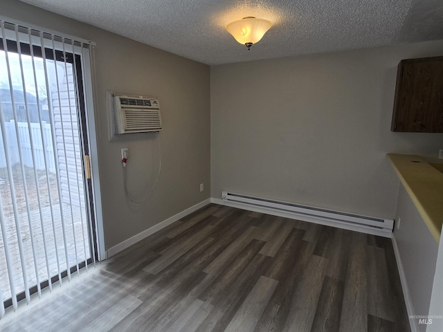 unfurnished dining area featuring an AC wall unit, dark hardwood / wood-style floors, a textured ceiling, and a baseboard heating unit