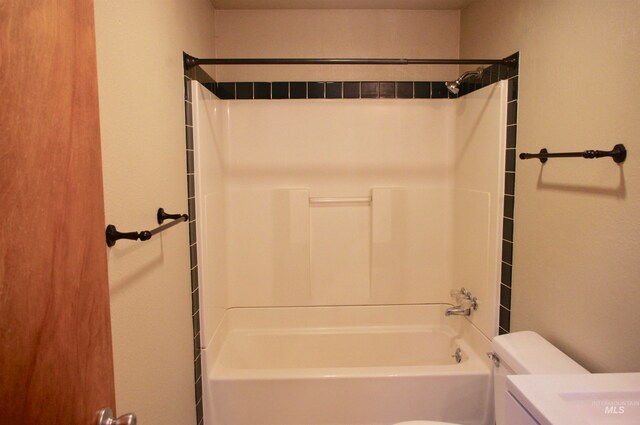 bathroom featuring toilet and shower / bathtub combination