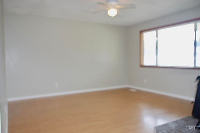 empty room with hardwood / wood-style flooring and ceiling fan