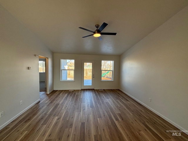 spare room featuring ceiling fan, dark hardwood / wood-style floors, and lofted ceiling