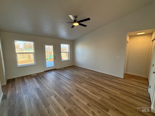 spare room featuring lofted ceiling, ceiling fan, and hardwood / wood-style flooring