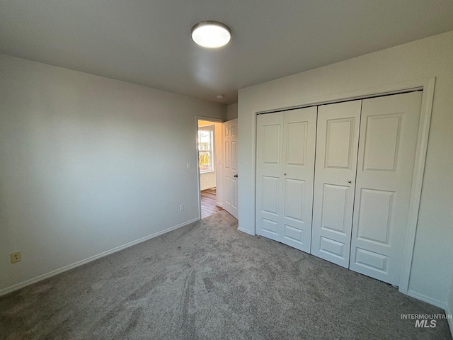 unfurnished bedroom with a closet and carpet