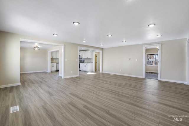 unfurnished living room featuring light wood-type flooring