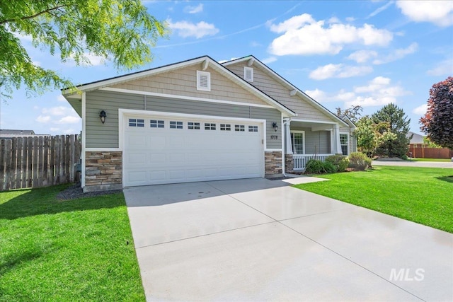 craftsman-style home with stone siding, concrete driveway, an attached garage, and covered porch