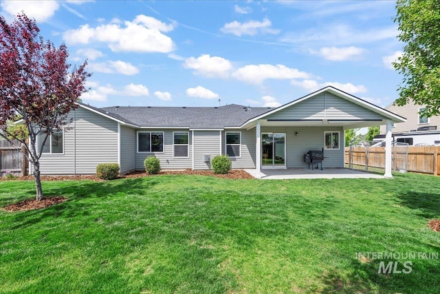 back of property featuring a patio and roof with shingles