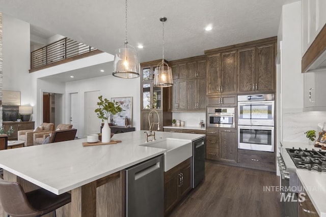 12975 Sandy Dr, Donnelly, ID 83615 - kitchen featuring appliances with stainless steel finishes, a sink, light countertops, a center island with sink, and recessed lighting