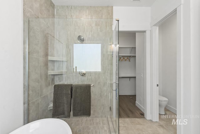 12975 Sandy Dr, Donnelly, ID 83615 - full bath featuring a shower stall, tile patterned flooring, and toilet