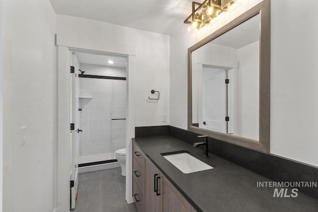 12975 Sandy Dr, Donnelly, ID 83615 - full bathroom with toilet, vanity, a stall shower, and tile patterned flooring