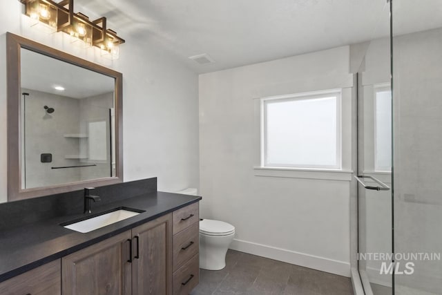 12975 Sandy Dr, Donnelly, ID 83615 - bathroom with vanity, toilet, a shower with door, and baseboards