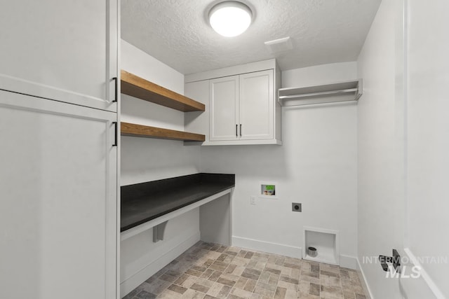 12975 Sandy Dr, Donnelly, ID 83615 - laundry room featuring hookup for an electric dryer, cabinet space, washer hookup, baseboards, and a textured ceiling