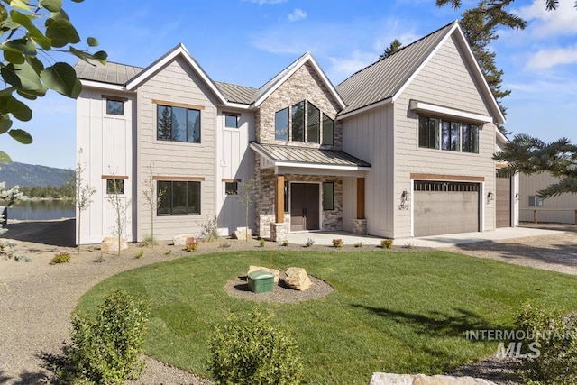12975 Sandy Dr, Donnelly, ID 83615 - view of front of property with a standing seam roof, concrete driveway, board and batten siding, an attached garage, and a front lawn