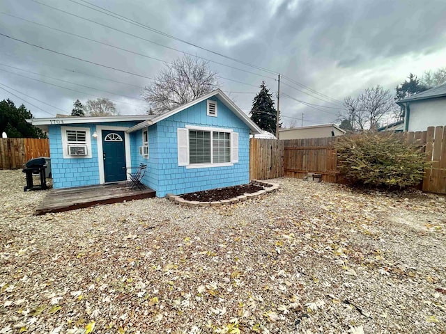 view of front of property featuring fence