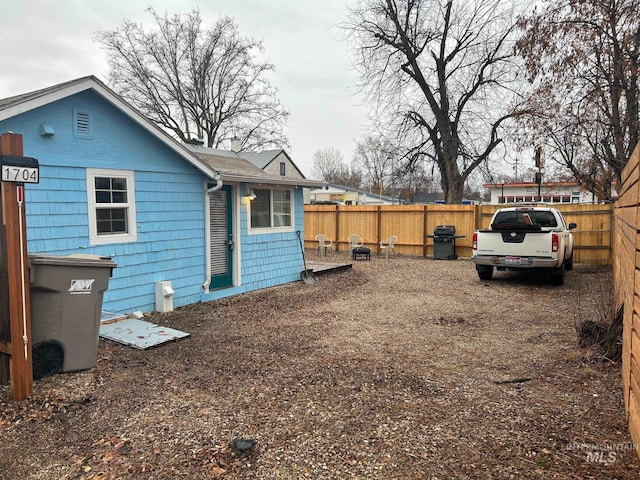 rear view of house featuring fence