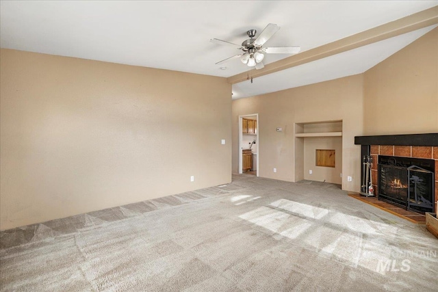 4240 N 1400 E, Buhl, ID 83316 - unfurnished living room with carpet flooring, a tiled fireplace, ceiling fan, and vaulted ceiling