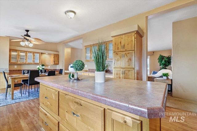 4240 N 1400 E, Buhl, ID 83316 - kitchen featuring glass insert cabinets, light wood-style flooring, and ceiling fan