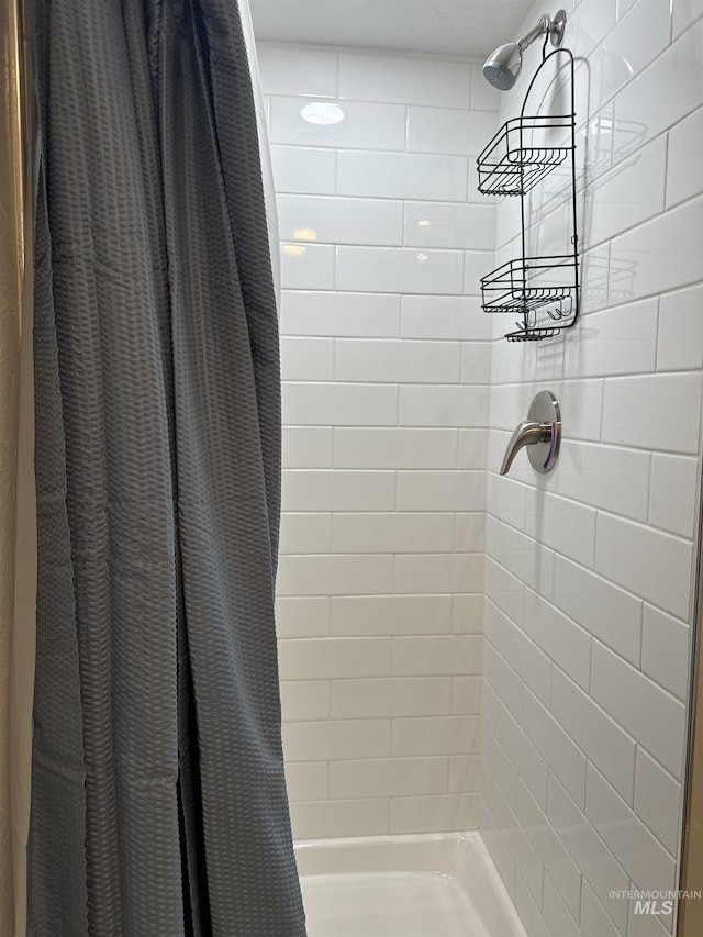 bathroom with a shower stall