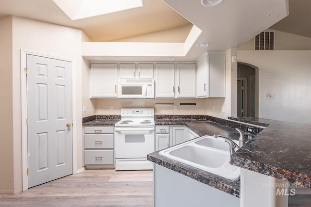 kitchen with light wood-style floors, visible vents, white cabinetry, and white appliances