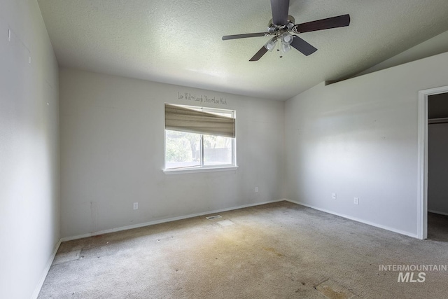 unfurnished room featuring carpet, a textured ceiling, and ceiling fan
