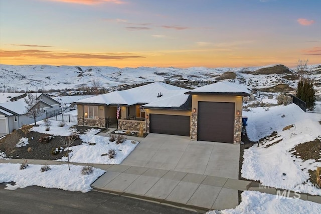 view of front of home featuring a mountain view and a garage