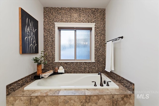 bathroom with tiled bath