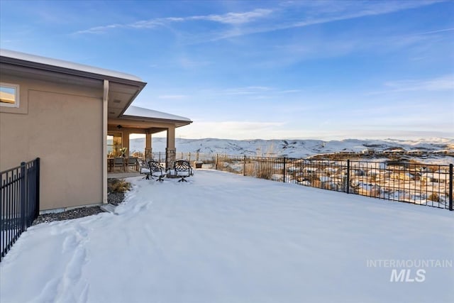 snowy yard with a mountain view