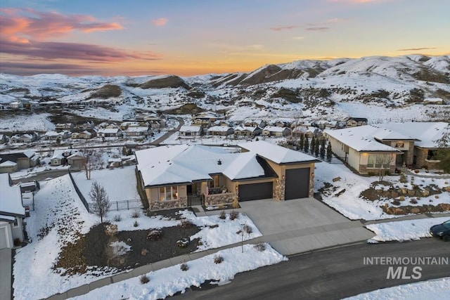 snowy aerial view featuring a mountain view