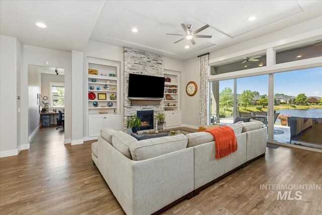 547 S Rivermist Ave, Star, ID 83669 - living room with a ceiling fan, wood finished floors, a fireplace, built in shelves, and recessed lighting