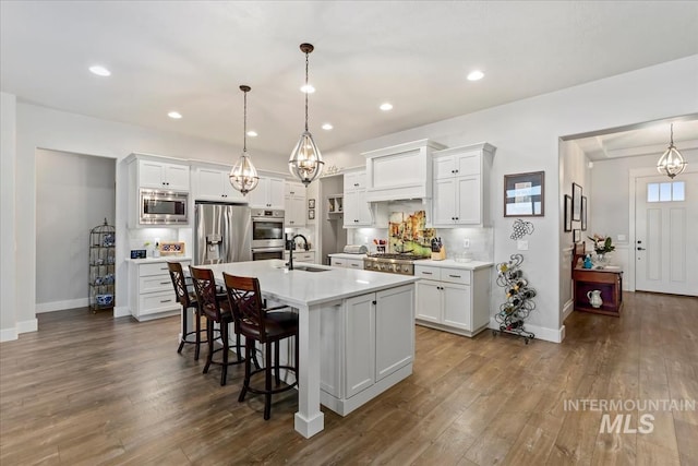 547 S Rivermist Ave, Star, ID 83669 - kitchen featuring stainless steel appliances, a breakfast bar area, light countertops, dark wood-style floors, and recessed lighting
